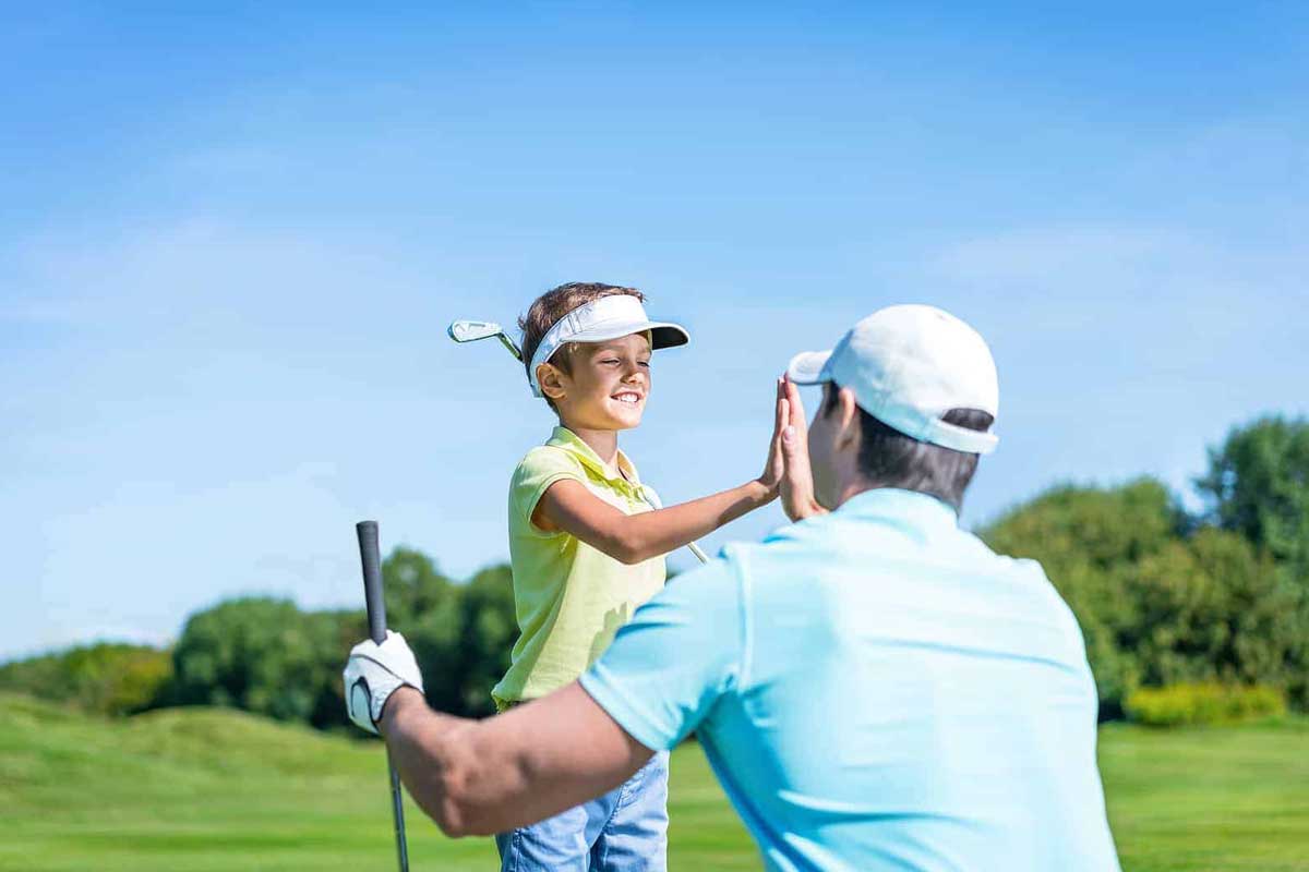 Golf Lessons & Clinics 5 a man and a little girl playing golf