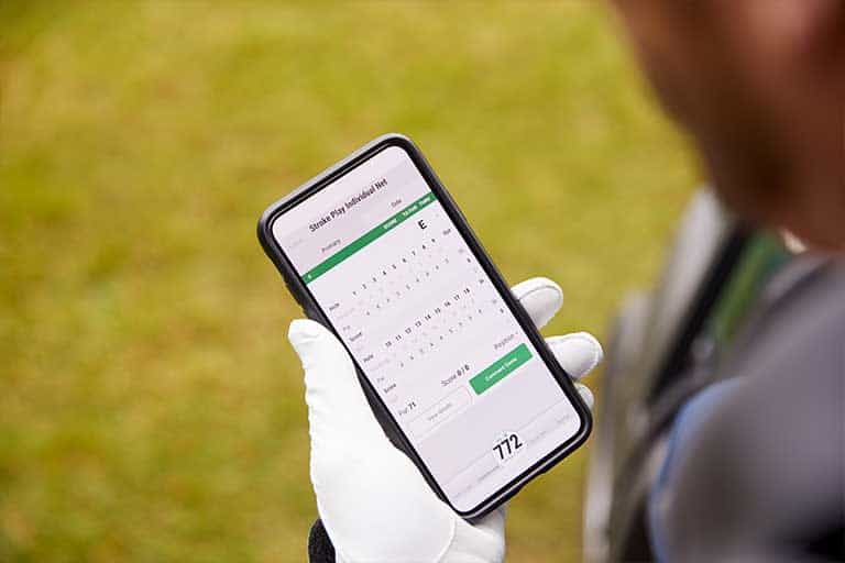 Cell phone etiquette on the golf course: When it’s OK to use your phone and when it should be put away. 1 Person holding a smartphone displaying a calendar schedule application.
