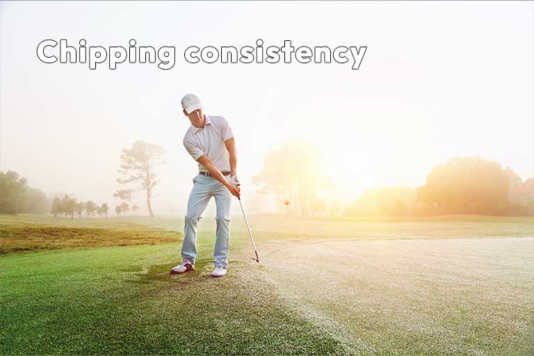 A golfer in a white outfit chips a golf ball on a sunny course at dawn with the text "Chipping consistency" above.