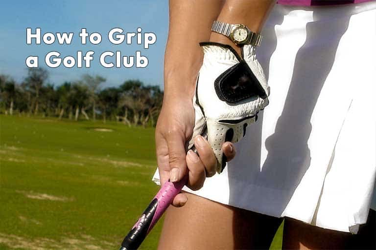 A close-up of a person holding a golf club, demonstrating a proper grip technique, with a caption "how to grip a golf club.