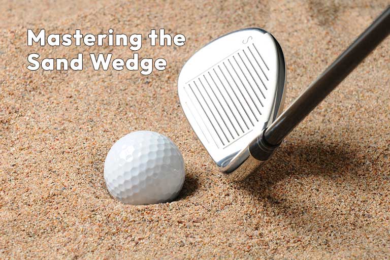 A sand wedge golf club and a golf ball in a sandy bunker. Text reads, "Mastering the Sand Wedge.