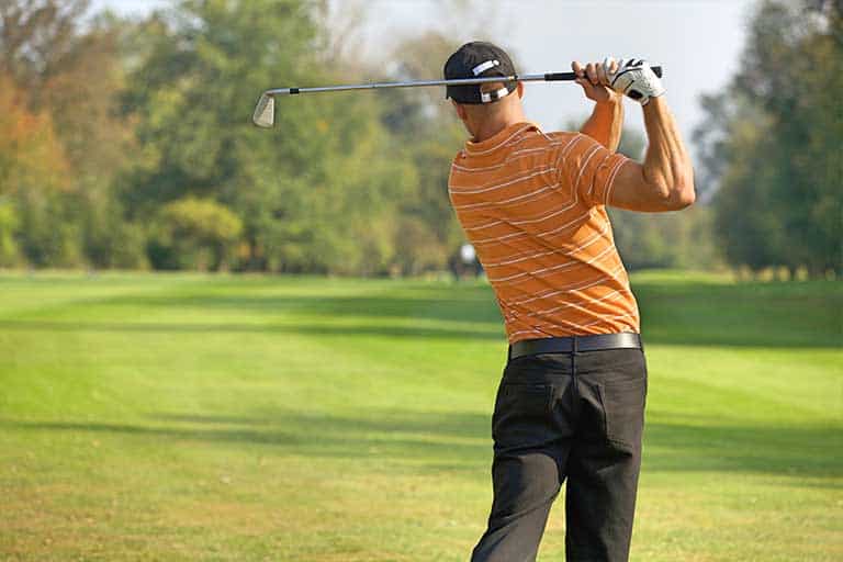 How to Improve Your Golf Swing: Step-by-Step Techniques 1 a man swinging a golf club this is  How to Improve Your Golf Swing